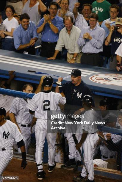 New York Yankees' Derek Jeter is congratulated by teammate David Wells after hitting a home run in the third inning of Game 2 of the 2002 American...