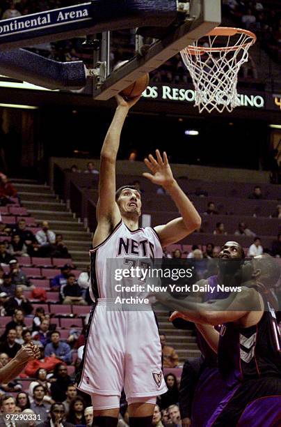 New Jersey Nets' #77 Gheorghe Muresan shoots during game against the Toronto Raptors at Continental Air Arena.