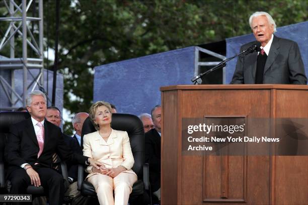 Former President Bill Clinton and his wife, Sen. Hillary Clinton, look on as the Rev. Billy Graham delivers his sermon to a crowd of about 80,000 on...