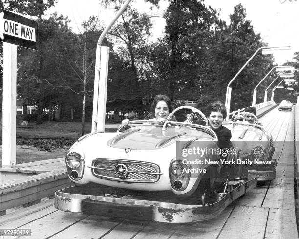 Manhattanites Erica Cordan, 10 and her sister, Olivia roar down the straightaway of the new turnpike ride at Palisades Amusement Park. A tailgating...