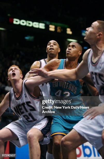 New Jersey Nets' Brian Scalabrine, Kenyon Martin and Aaron Williams battle New Orleans Hornets' P.J. Brown for a rebound during second half of game...