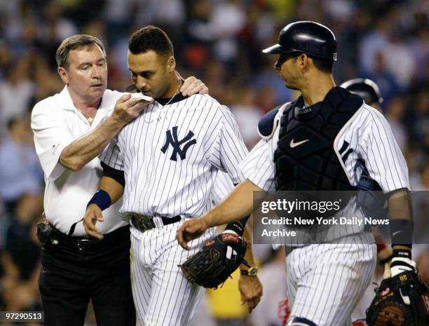 New York Yankees' Derek Jeter leaves game after making run-saving catch on popup by Boston's Trot Nixon in 12th during game against the Red Sox.