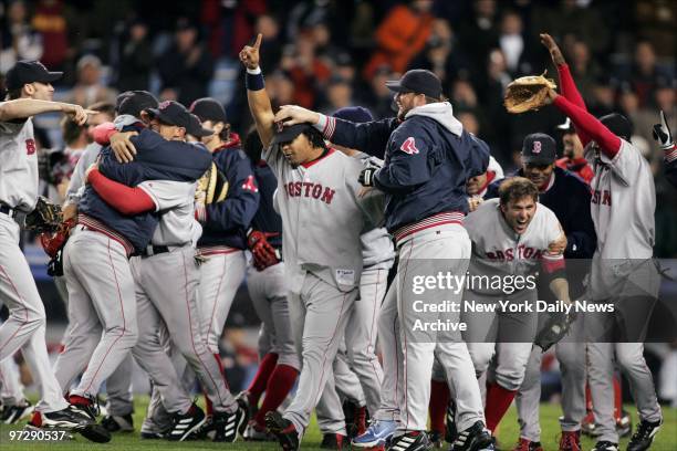 Manny Ramirez points out that the Boston Red Sox are No. 1 as players celebrate on the field after their 10-3 victory over the New York Yankees in...