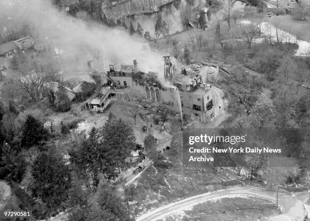 Mansion Destroyed by Fire. Thick smoke rises from the roof of burning 85-room mansion in Laurel Hollow as firemen battle to control the blaze. The...