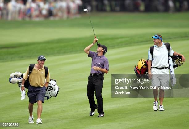 Sergio Garcia has some fun trying to balance a golf club on his nose as he walks up the 17th fairway during his practice round at the 87th PGA...