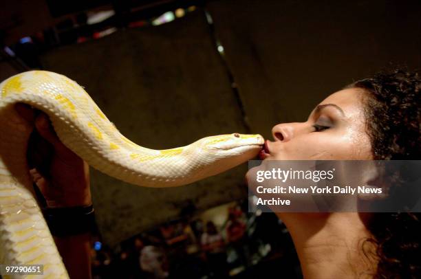 Serpentina gives her 7-year-old python, Orangina, a smooch as she and other Coney Island Circus Sideshow performers promote a new line of Coney...