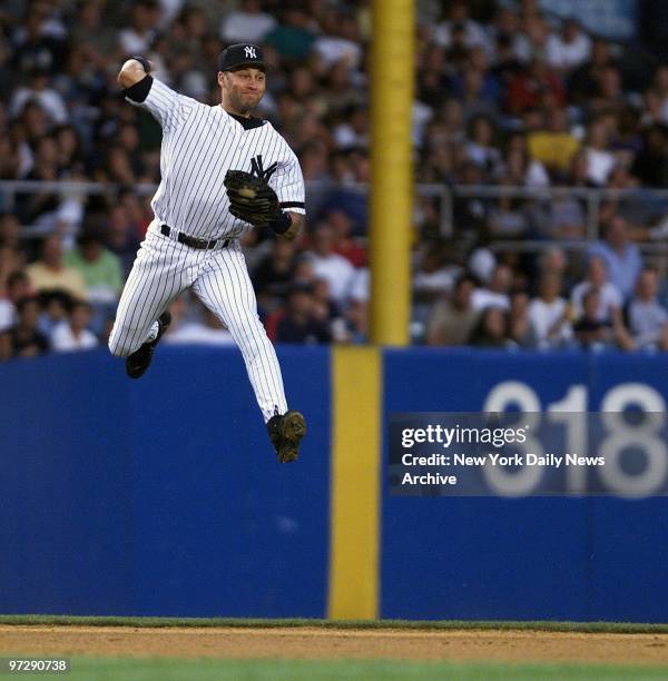 New York Yankees' Derek Jeter makes a throw to second resulting in a fielder's choice in the fifth inning against the Baltimore Orioles at Yankee...