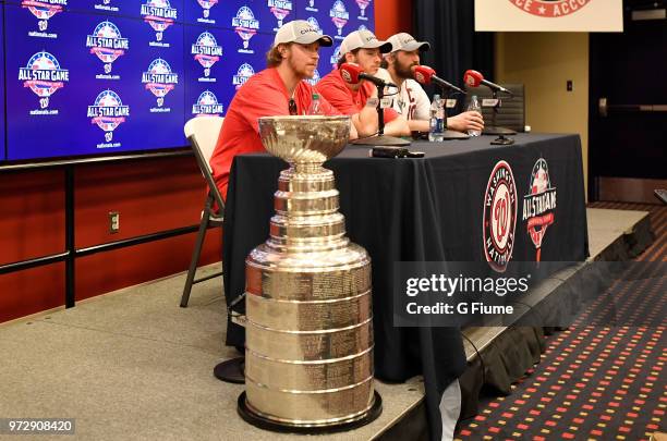 Nicklas Backstrom, John Carlson and Alex Ovechkin of the Washington Capitals talk with the media at Nationals Park on June 9, 2018 in Washington, DC.