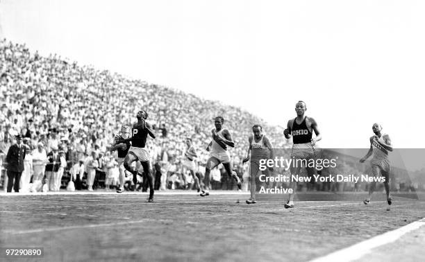 Setting a new record, Jesse Owens wins the 200-meter in 21 seconds flat on the last day of the Olympic trials at the municipal Triborough Stadium on...