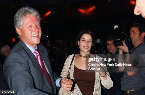 Former President Bill Clinton gets together with actress Neve Campbell during a celebration of the Mohegan Sun casino's $1 billion expansion in...