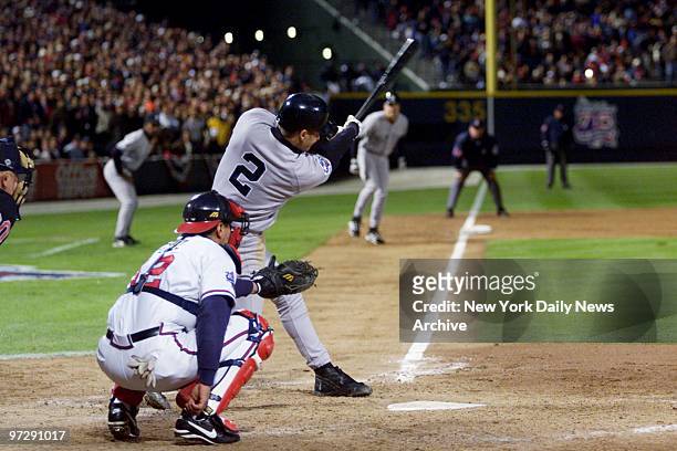New York Yankees' Derek Jeter singles in the eighth inning to score Scott Brosius from third base during Game 1 of the World Series against the New...