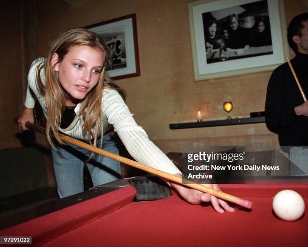 Seventeen-year-old Ford supermodel Bridget Hall shoots a game of pool at a party celebrating her contract with Ralph Lauren for his women's wear line.