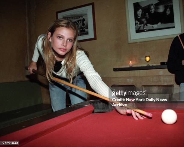 Seventeen-year-old Ford supermodel Bridget Hall shoots a game of pool at a party celebrating her contract with Ralph Lauren for his women's wear line.