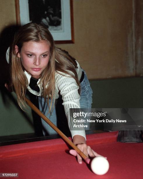 Seventeen-year-old Ford supermodel Bridget Hall shoots a game of pool at a party celebrating her contract with Ralph Lauren for his women's wear line.