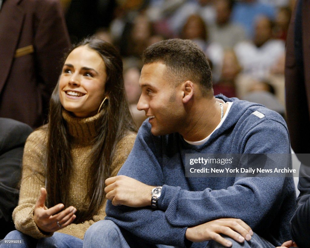 New York Yankees' Derek Jeter sits courtside with girlffrien