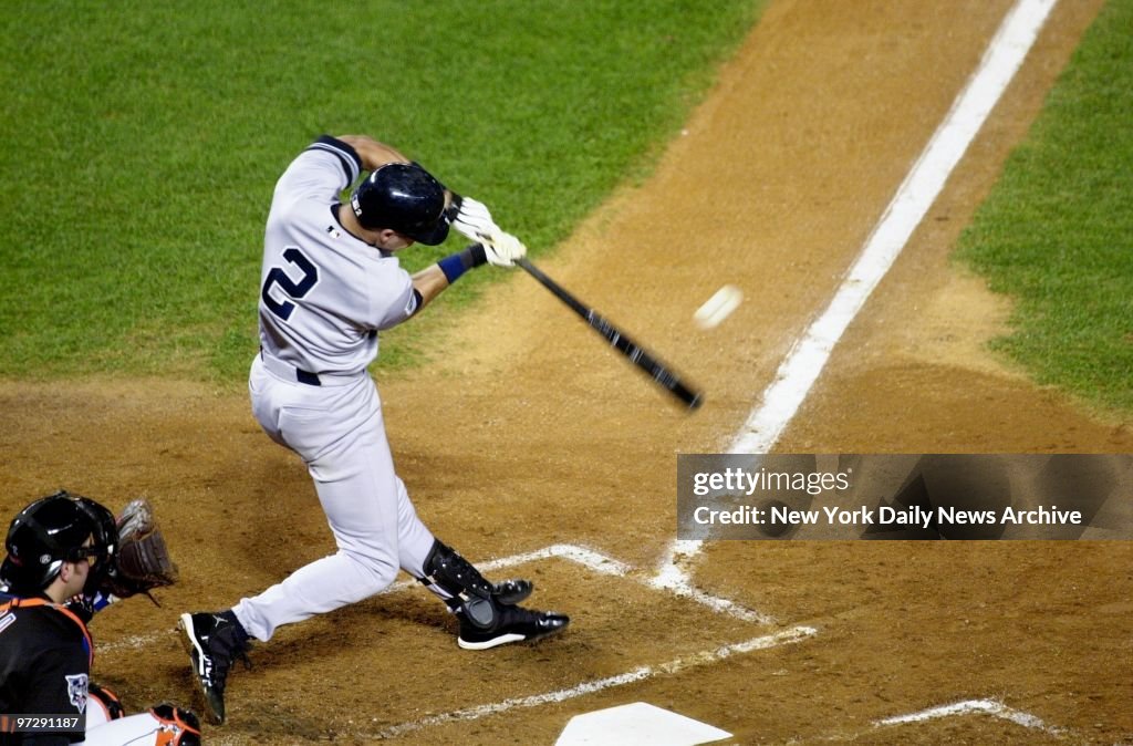New York Yankees' Derek Jeter smacks the first pitch of the