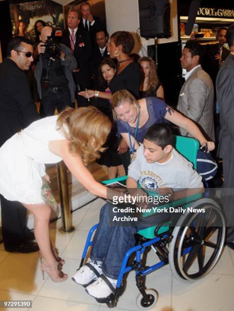 Jennifer Lopez at Macy's with her new Fragrance Launch for "Deseo For Men" . She stops to greet a young fan.