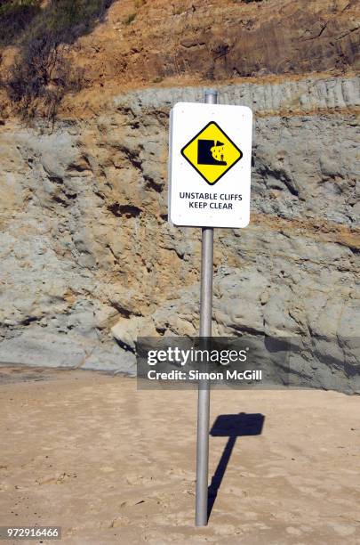 'unstable cliffs: keep clear' sign, north wollongong beach, new south wales, australia - hazardous area sign stock pictures, royalty-free photos & images