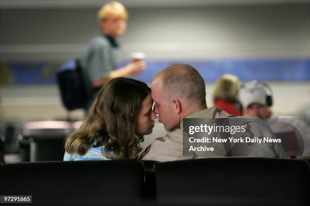 Sgt. Anthony Willingham of Centre, Ala., kisses his new wife, Theresa, at Hartsfield-Jackson Atlanta International Airport. Willingham, who married...
