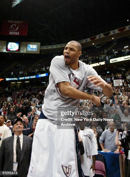 New Jersey Nets' Kenyon Martin celebrates as he slips on his new T-shirt, which reads "Champions," after the Nets defeated the Detroit Pistons,...