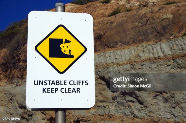 'unstable cliffs: keep clear' sign - hazardous area sign stock pictures, royalty-free photos & images