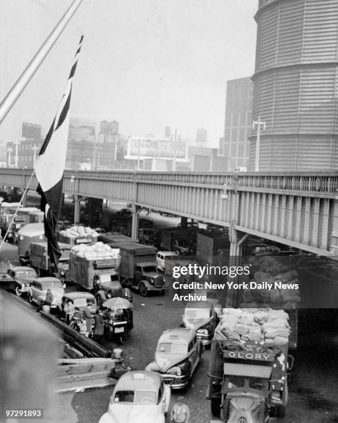 Trucks lined up at Pier 84 on the Hudson River, to load goods on the Exeter and the Vulcania.