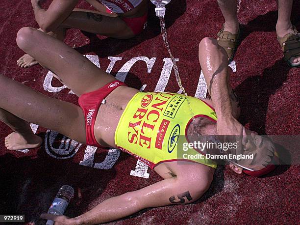 Steve Pullen of Australia collaspes over the finsh line after finshing round two of the Uncle Toby's Ironman Super Series held at Coolangatta beach...