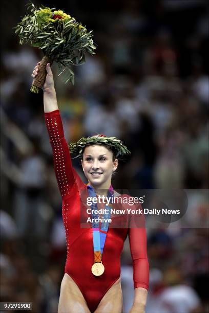 Carly Patterson acknowledges the cheers of the crowd after receiving the gold medal for her winning performance in the all-around gymnastics...