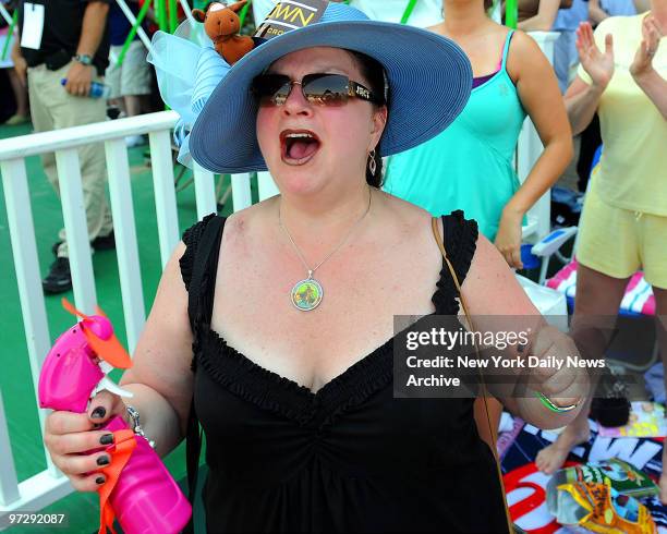 Jennifer Starr of Wilkes-Barre, PA, uses a battery-powered fan with spritzer to stay cool while rooting on an earlier race at the running of the...