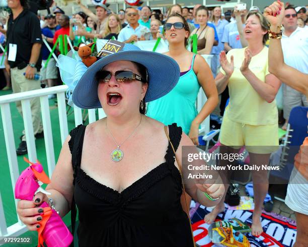 Jennifer Starr of Wilkes-Barre, PA, uses a battery-powered fan with spritzer to stay cool while rooting on an earlier race at the running of the...