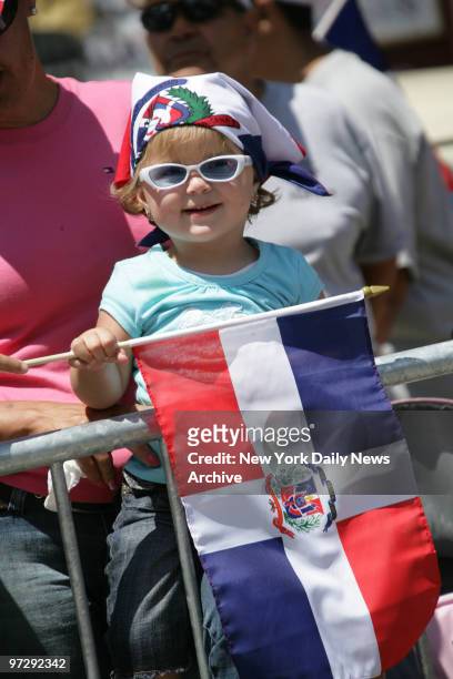 Shanellie Aristy, 1 yr 9 mos old celebrates the Dominican Day Parade on the Grand Concourse in the Bronx.