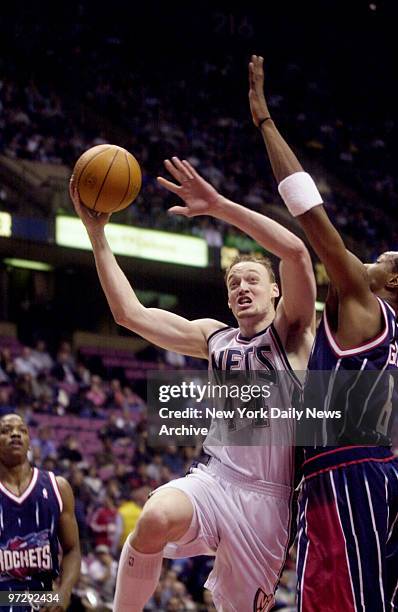 New Jersey Nets' Keith Van Horn drives by Houston Rockets' defender at Continental Airlines Arena.The Nets won, 106-94.