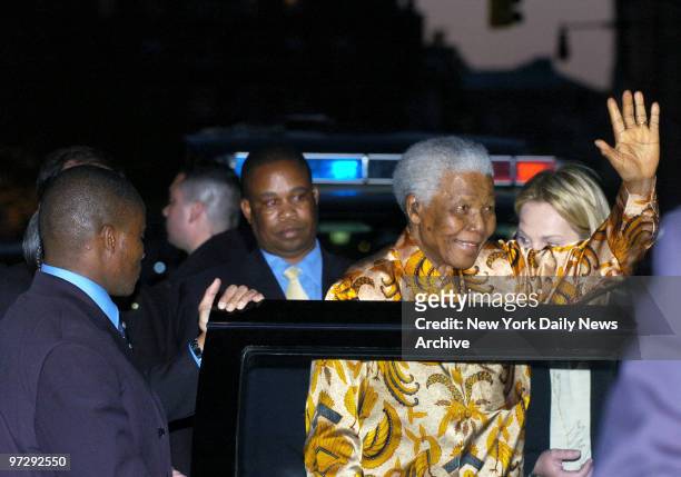 Former South African President Nelson Mandela waves to the crowd as he gets into his car outside the Tribeca Grill after a gala dinner hosted by...