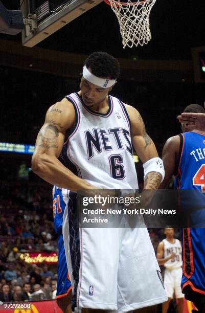 New Jersey Nets' Kenyon Martin flexes his muscles after making a shot during game against the New York Knicks at Continental Airlines Arena. Martin...