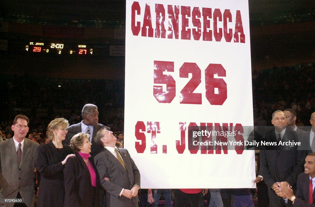 Former St. John's basketball coach Lou Carnesecca gazes up a