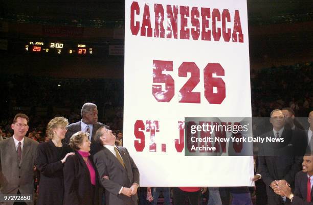 Former St. John's basketball coach Lou Carnesecca gazes up at banner bearing his name and victory total in 24 years at the helm of the team in...