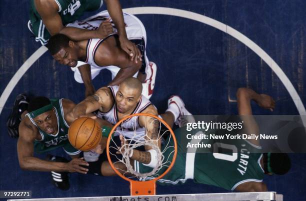 New Jersey Nets' Kenyon Martin scores in close against Boston Celtics' Paul Pierce and Walter McCarty during Game 2 of the Eastern Conference...
