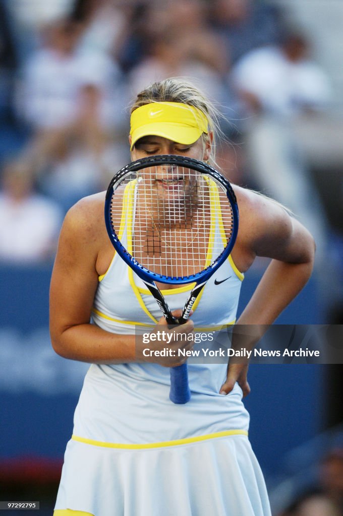 Maria Sharapova of Russia talks to her racquet as she takes