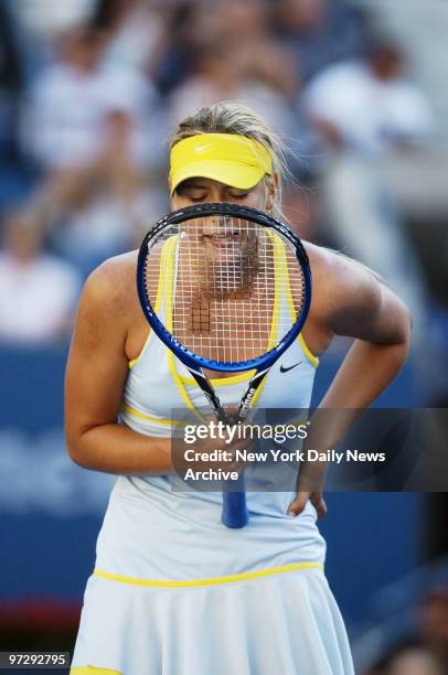 Maria Sharapova of Russia talks to her racquet as she takes on Kim Clijsters of Belgium in the U.S. Open women's singles semifinals at Arthur Ashe...