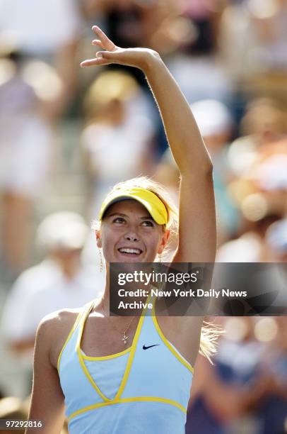 Maria Sharapova of Russia waves to the crowd after defeating Julia Schruff of Germany in third round play in the U.S. Open at Arthur Ashe Stadium in...