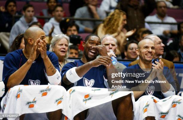 New Jersey Nets' Kenyon Martin, Rodney Rogers and Jason Kidd cheer as their team defeats the Cleveland Cavaliers, 120-79, at the Continental Airlines...