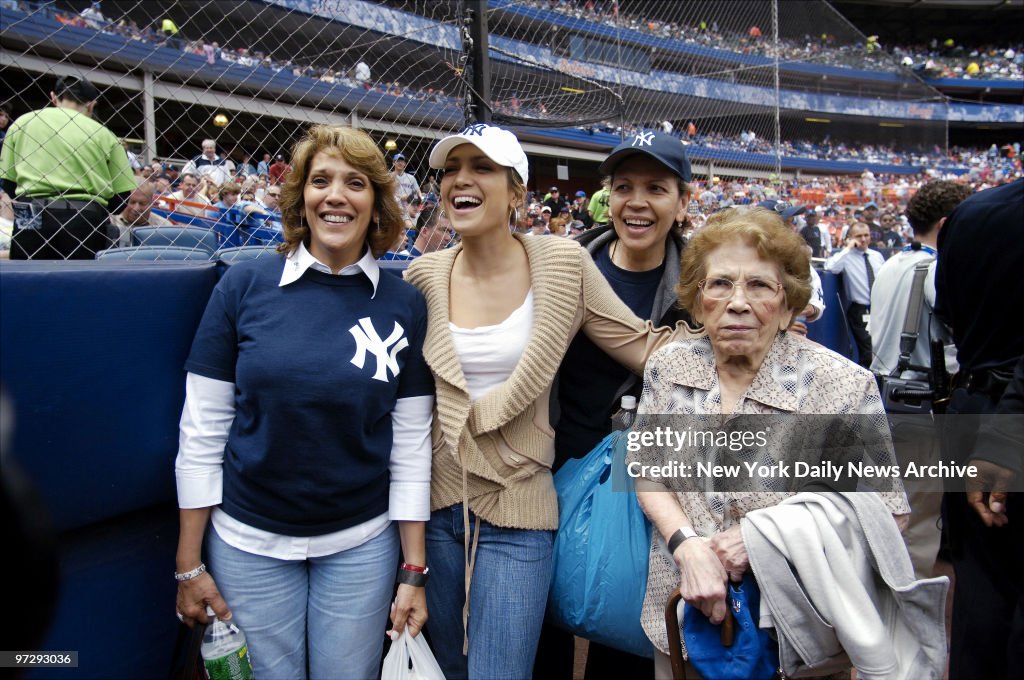New York Yankees' fan Jennifer Lopez (white cap) takes mom G