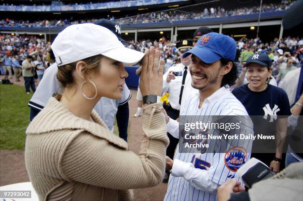 New York Yankees' fan Jennifer Lopez and her husband, New York Mets' fan Marc Anthony, are on hand for Game 2 of a three-game Subway Series at Shea...