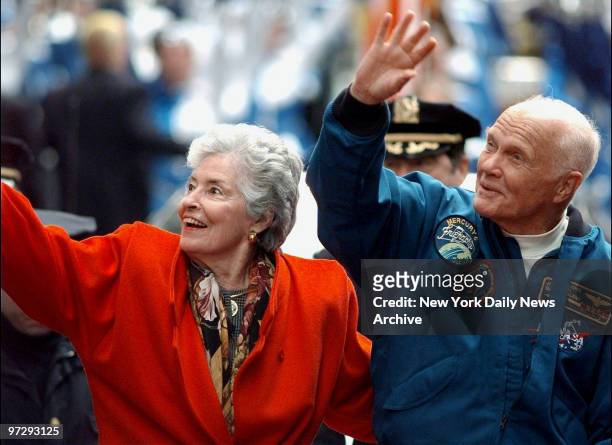 John Glenn and wife Annie greet crowd from open car in parade up lower Broadway honoring Glenn and crew of the Discovery space shuttle.