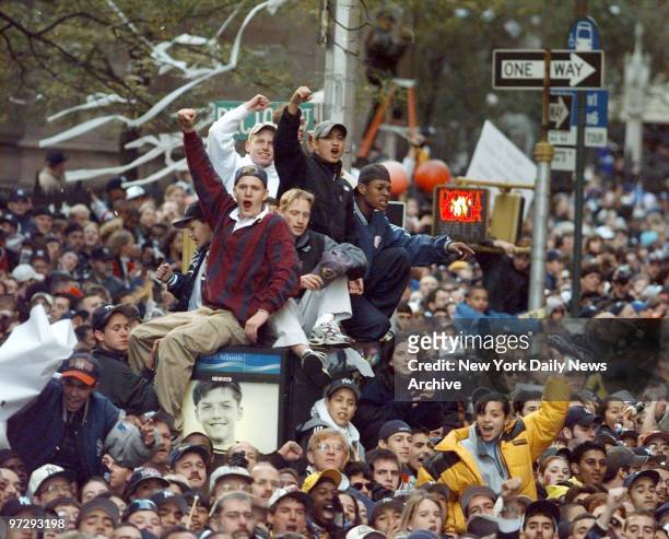 New York Yankees' fans cheer during ticker tape parade held in honor of the Yankees' World Series victory.