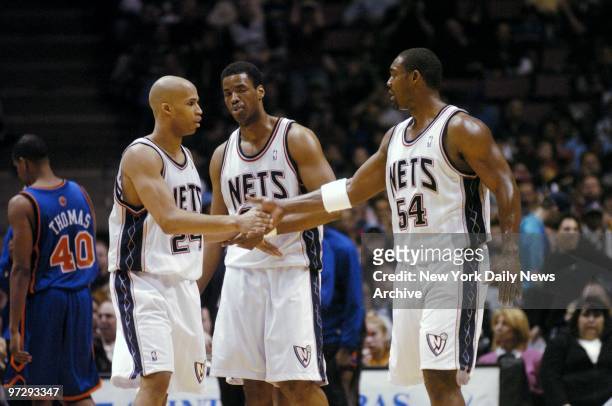 New Jersey Nets' Richard Jefferson slaps hands with Rodney Rogers during first half of game against the New York Knicks at Continental Airlines...