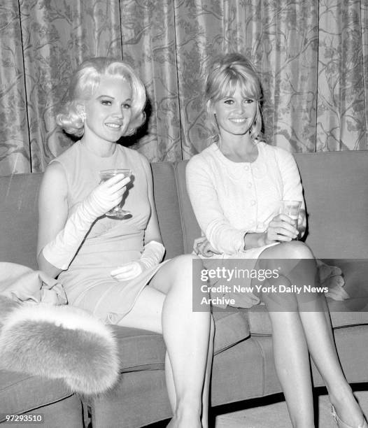 Carole Baker meets Brigitte Bardot in lounge at Kennedy Airport.