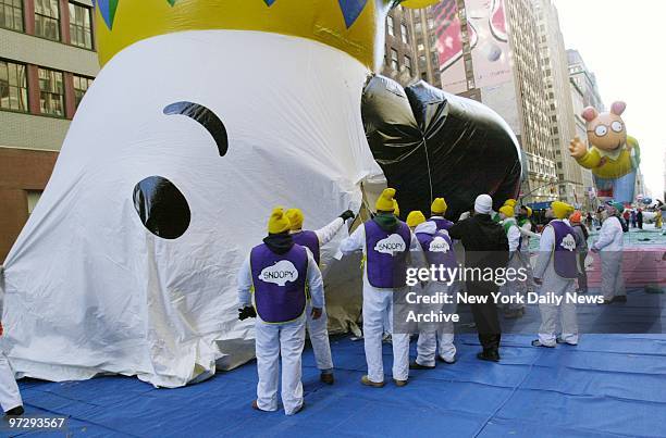 The Snoopy balloon is deflated after the 74th annual Macy's Thankgiving Day Parade. Next to go is Arthur the Aardvark in the background.