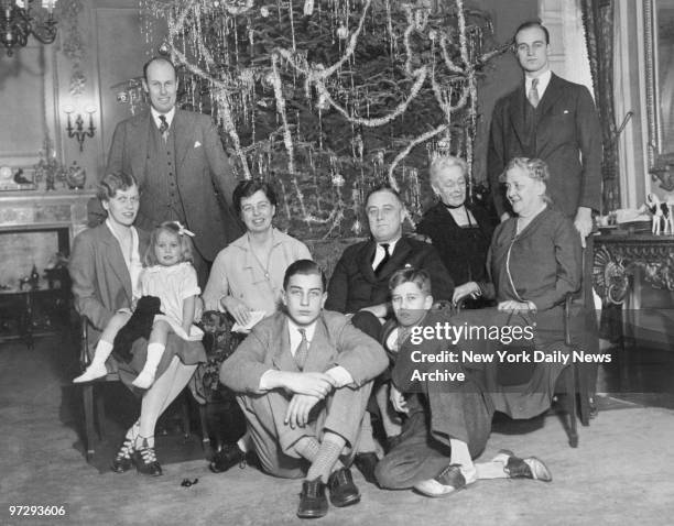 Four generations of Roosevelts around Christmas tree at Executive Mansion. Front row: Franklin D. Roosevelt Jr. And John A. Roosevelt. Second row :...
