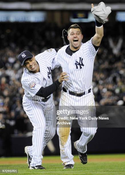 Jerry Hairston Jr. And Nick Swisher celebrate after the New York Yankees win the World Series by defeating the Philadelphia Phillies 7-3, in Game 6,...